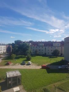 a view of a park with buildings in the background at Irra Apartment in Gdańsk