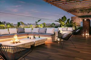 a patio with a couch and a fire pit at Elegant 1BR in San Isidro / Pool in Lima