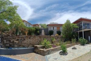 a home with a retaining wall and a yard at SapphireA@54 in Windhoek