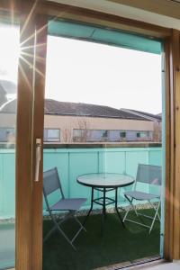 a patio with a table and chairs on a balcony at Number1Townhouse with private balcony & Parking in Glasgow