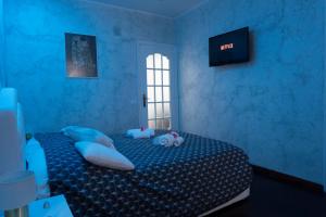 a bedroom with a bed with two stuffed animals on it at TIMEO central apartment in historic sicilian baroque-style building in Catania
