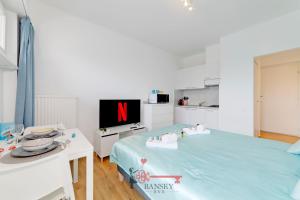 a bedroom with a large blue bed with a tv at Tiffany's Studio - Lugano in Style -By EasyLife Swiss in Lugano