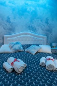 a bed with towels and pillows on it at TIMEO central apartment in historic sicilian baroque-style building in Catania