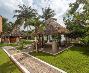 a resort with palm trees and a table and chairs at Royal lagoon room in Cancún