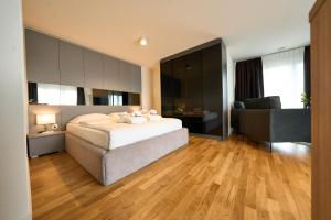 a bedroom with a bed and a living room at Cartea Apartments Zürich Airport in Opfikon