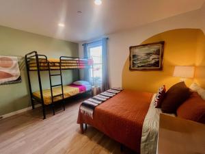 a bedroom with two bunk beds and a window at Monterey Hostel in Monterey