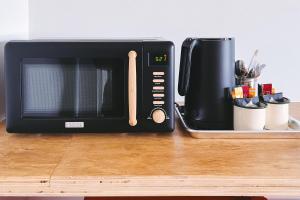 a black microwave sitting on top of a counter at The Timberline in Leadville