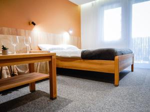 a bedroom with a bed with a window and a table at SEA-PORT Resort in Łeba