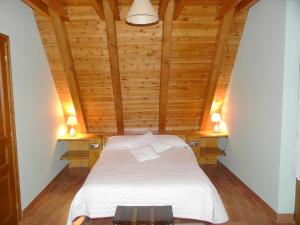 a bedroom with a bed in a wooden ceiling at 3 bedrooms chalet with city view furnished garden and wifi at Viella in Vielha