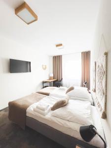 a bedroom with a large bed with a tv on the wall at Beskidian in Węgierska Górka