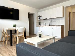 a living room with a couch and a table at Willa Uliaszówka in Szczawnica