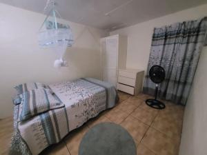 a bedroom with a bed and a fan in it at The Cupid Chalet in Belmont