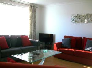 a living room with two couches and a coffee table at Number 8 in Bury Saint Edmunds