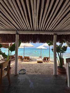 a beach with chairs and umbrellas and the ocean at Cristal Blue Barú in Baru