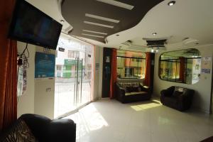a train car with couches and a flat screen tv at Hotel Frontera in Tacna