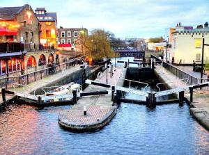 a group of boats docked in a river with buildings at Spacious Comfy 2BR flat in London