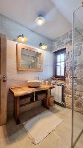 a bathroom with a sink and a mirror at Butina Guesthouse in Kuterevo +67 photos