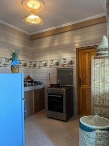 a kitchen with a stove top oven in a room at rise surf and yoga morocco in Agadir