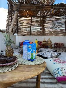 a room with a table with milk and pillows at rise surf and yoga morocco in Agadir