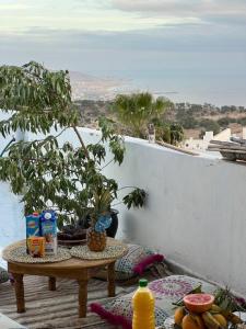 a table on a balcony with food on it at rise surf and yoga morocco in Agadir