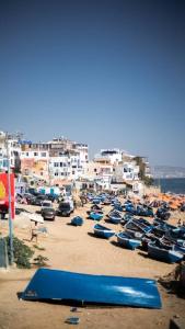 a group of boats parked on a beach with buildings at rise surf and yoga morocco in Agadir