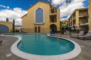 a swimming pool in front of a building at Best Western Moreno Hotel & Suites in Moreno Valley
