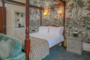 a bedroom with a canopy bed and a chair at Best Western Forest and Vale Hotel in Pickering