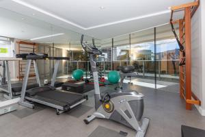 a gym with treadmills and machines in a room at Apto 750m da UFSC, Sacada com Churrasqueira e Academia FU3431 in Florianópolis