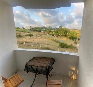 a window with a bench in a room with a view at Airport apartements in Arnavutköy