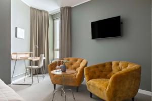 a living room with a couch and a chair at Best Western Hotel River C in Karlstad