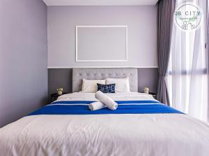a bedroom with a large bed with blue and white at D'Pristine Suites by JBcity Home in Nusajaya