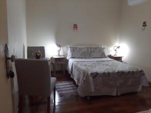 Een bed of bedden in een kamer bij Pousada As Relíquias de Minas
