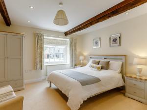 a bedroom with a large bed and a window at 3 Bed in Tiverton 53565 in Cullompton
