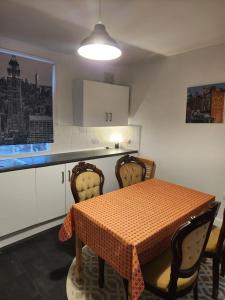 a kitchen with a table and chairs and a table and a window at Oval Cricket Ground walking distance in London