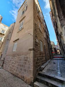 a tall brick building with stairs leading up to it at Pocco Andante in Dubrovnik