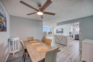 a dining room with a table and a ceiling fan at Huge Beachfront Condo on Maderia Beach in St. Pete Beach