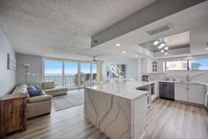 a kitchen and living room with a view of the ocean at Huge Beachfront Condo on Maderia Beach in St. Pete Beach
