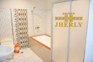 a bathroom with a shower and a toilet and a sink at HOTEL JHERLY in Nuevo Tingo