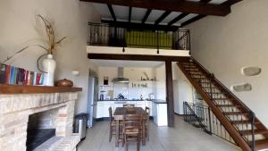 a kitchen and dining room with a staircase and a living room at Murisengo Country Houses in Murisengo