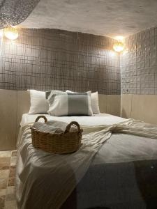 a bedroom with a bed with a basket on it at Amaan ⴰⵎⴰⴰⵏ Cottage in Agadir