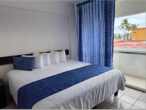 Postel nebo postele na pokoji v ubytování Hotel Delfín Vista Pier Beach Front