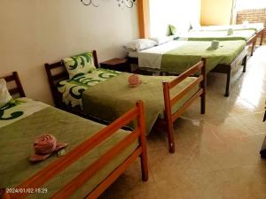 a room with three beds in a room at Hotel Dorado Real in Fusagasuga