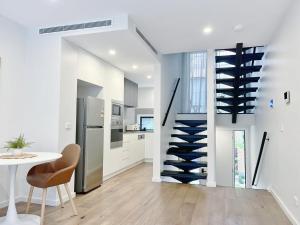 a kitchen with a staircase with a wine cellar at Inn Central Townhouse at Canberra in Canberra