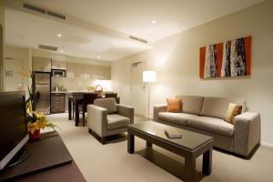 a living room with a couch and a table at Quest Alice Springs in Alice Springs