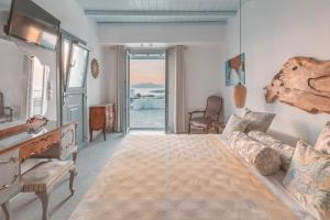a bedroom with a bed and a living room at Villa Konstantin in Mikonos