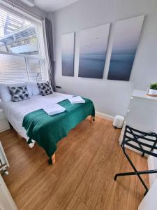 a bedroom with a bed and a large window at Portrush by the Sea - 1 West Beach in Portrush