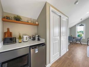 a kitchen with a sink and a counter with a microwave at Figtree Loft in Rothbury