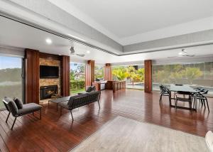 a large living room with a table and chairs at Blissful Bungalow Batemans Bay managed by Batemans Bay Accom in Batemans Bay