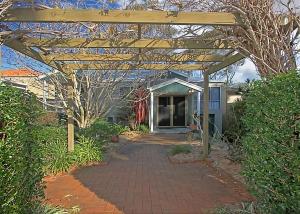 a pergola over a walkway in front of a house at Denham Avenue Whole House Beachside Escape managed by Batemans Bay Accom in Surf Beach