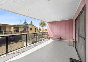 an empty balcony with a view of a house at Golfers Dream managed by Batemans Bay Accom in Batemans Bay